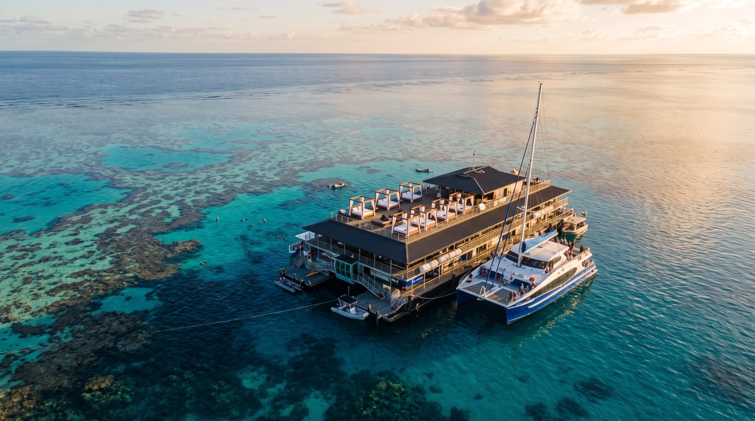 Sleeping on the Great Barrier Reef: Reefsleep and Reefsuite at Cruise Whitsundays' Reefworld (2026 Guide) 1 Reefworld pontoon on Hardy Reef at golden hour, where the Reefsuite Whitsundays and Reefsleep overnight stays are based